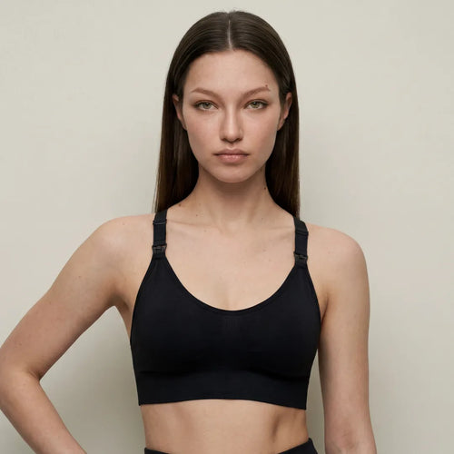 Black active nursing bra smooth cup with drop-clip strap nursing access, upper body studio portrait shot
