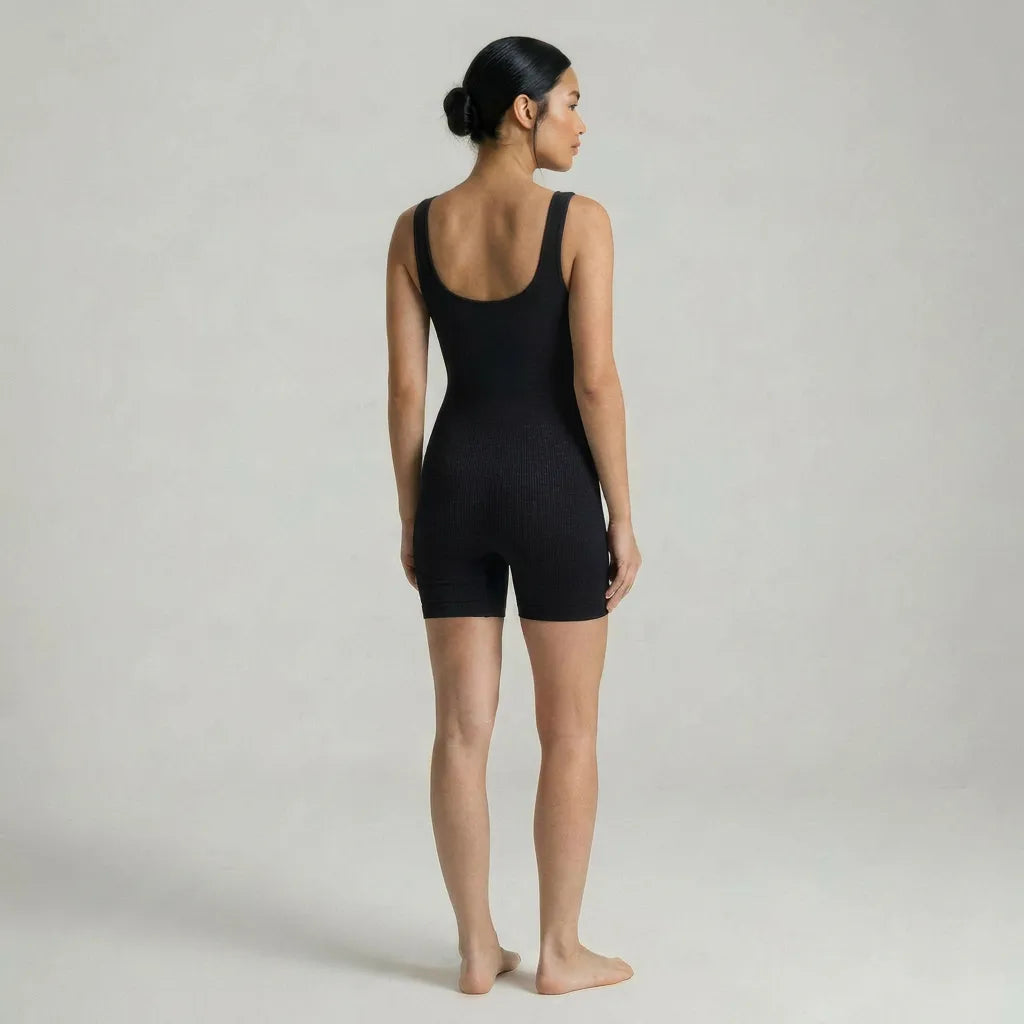 Black maternity seamless bodysuit scoop back neckline, full length rear studio view