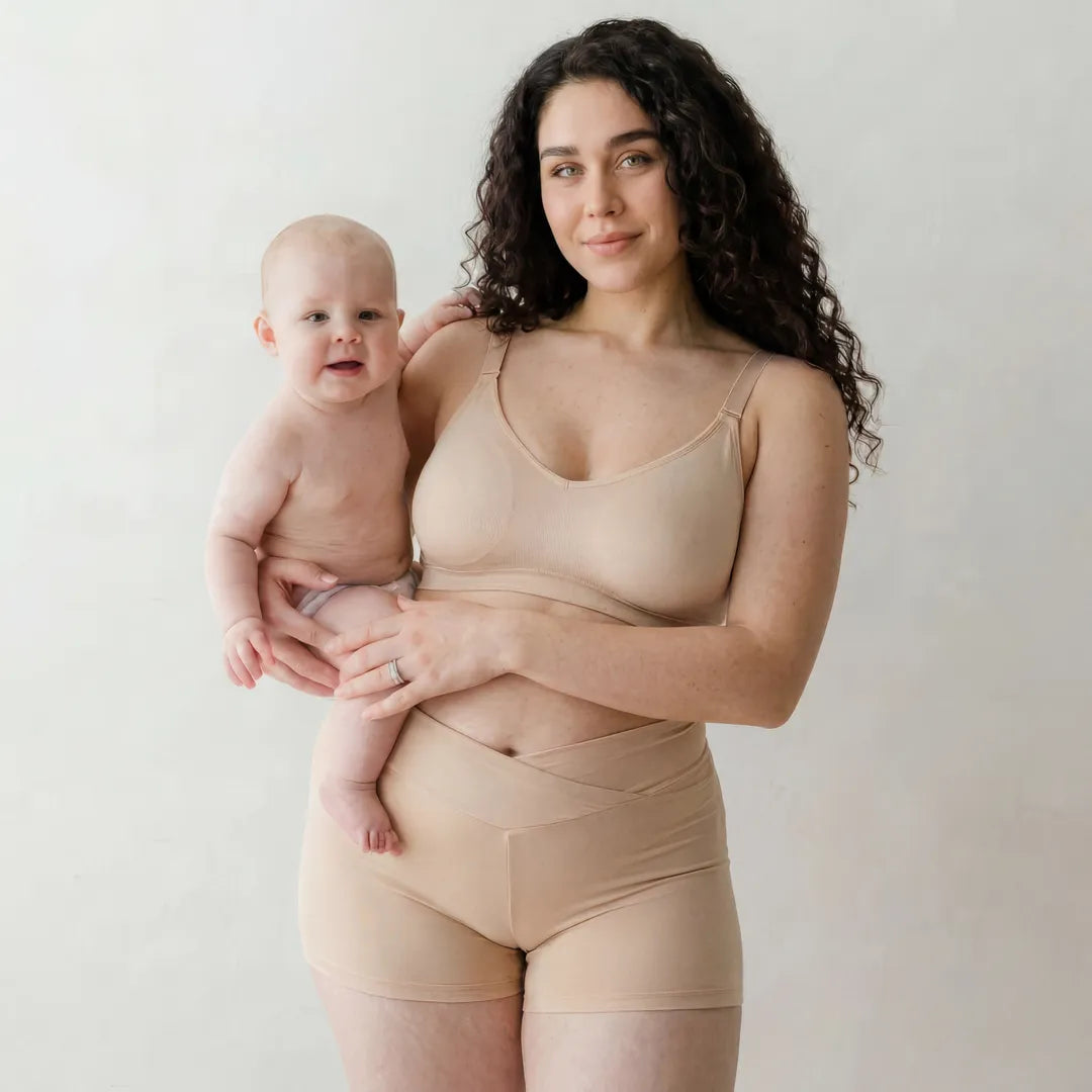 Nude maternity bump support short crossover waistband, lifestyle with baby