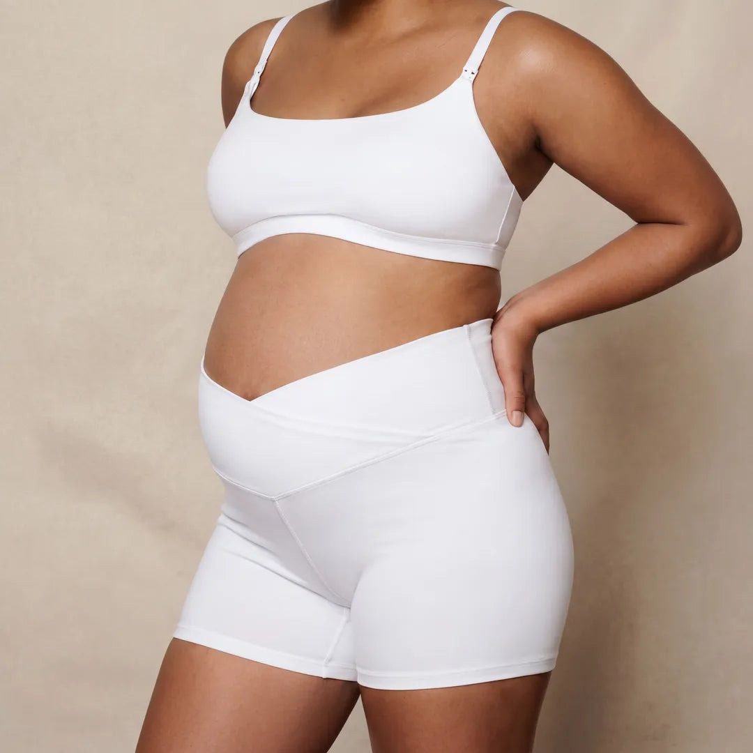 White maternity bump support short crossover waistband, pregnant model front close view