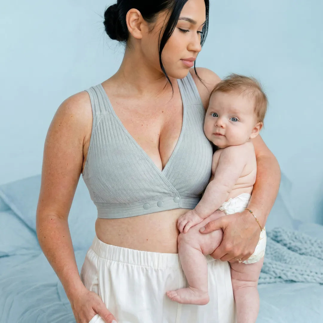 Light blue nursing cotton bra ribbed wide strap wrap front, lifestyle postpartum holding newborn shot