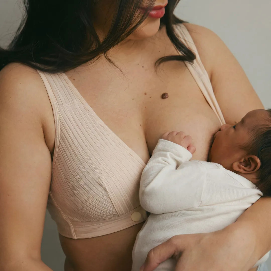 Nude nursing cotton bra ribbed wrap front with pull-aside nursing access, close-up breastfeeding detail shot