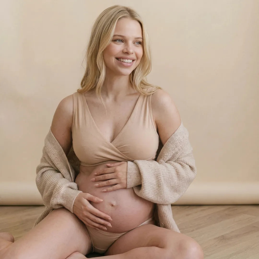Nude nursing bra crossover wrap front, pregnant model seated view