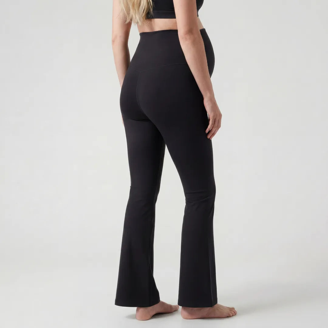 Black maternity flare leggings back view, full length studio shot