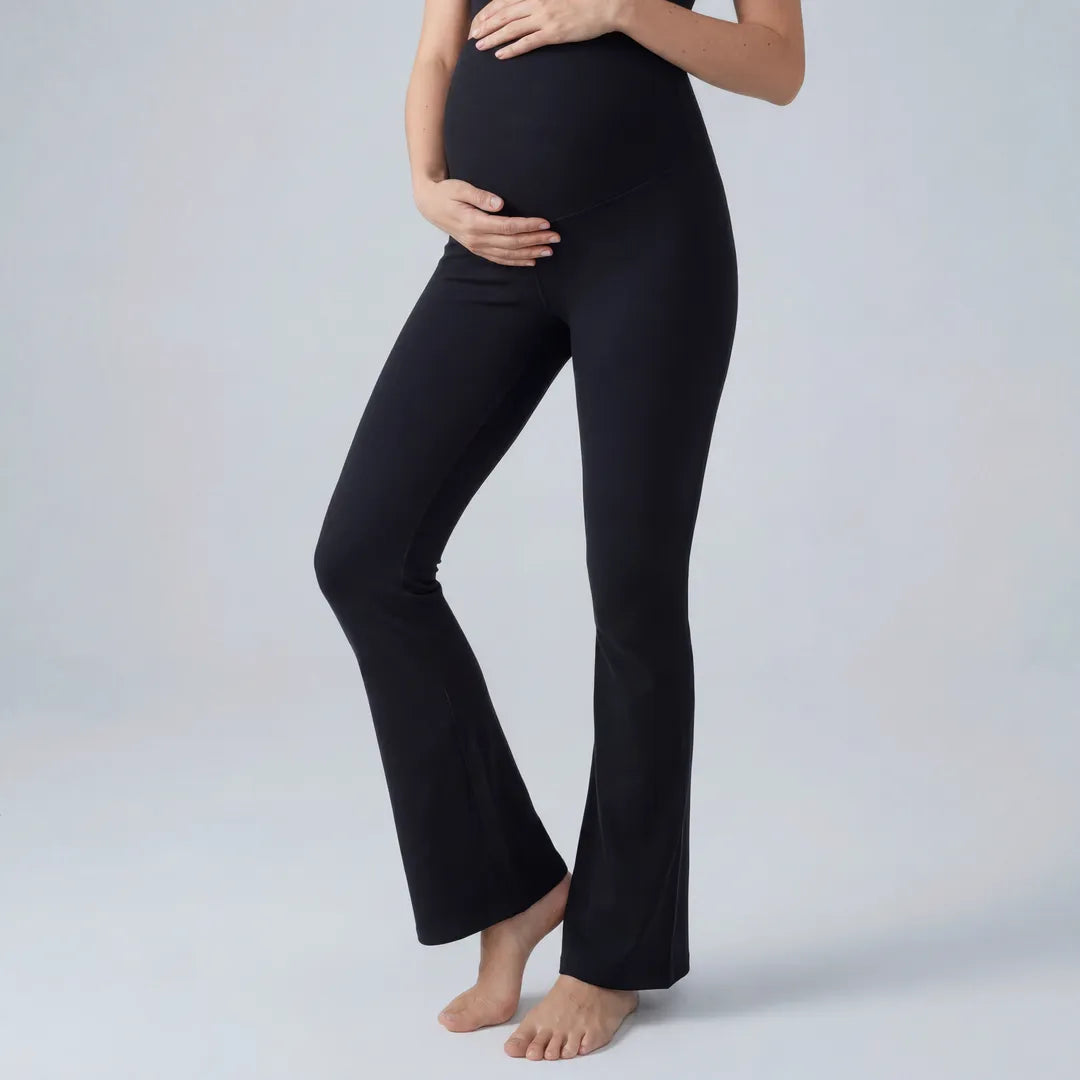 Black maternity flare leggings with over-bump panel, side view