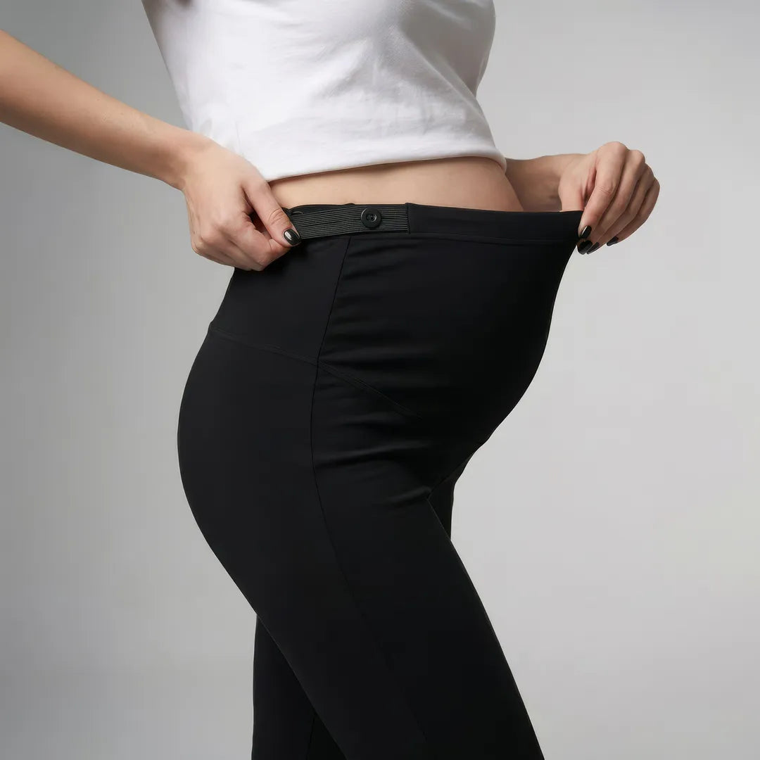 Black maternity flare leggings over-bump waist panel detail, close-up