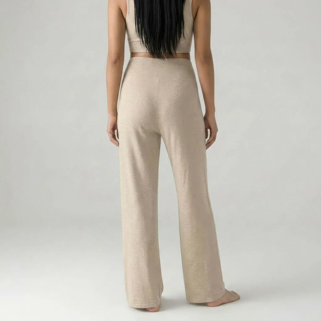 Person wearing beige pants and top on a plain background