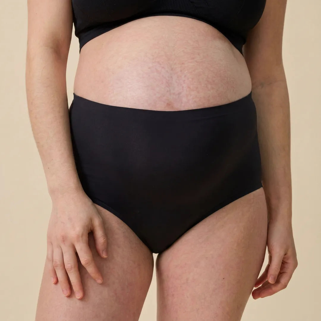 Black maternity seamless brief high-rise belly support, pregnant model front view