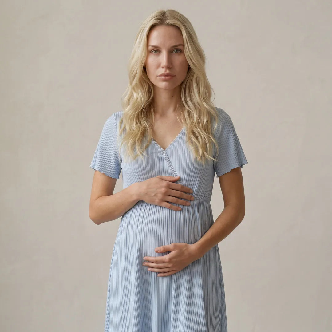 Blue maternity night nursing dress ribbed wrap front with lace trim, half body maternity hands on bump shot