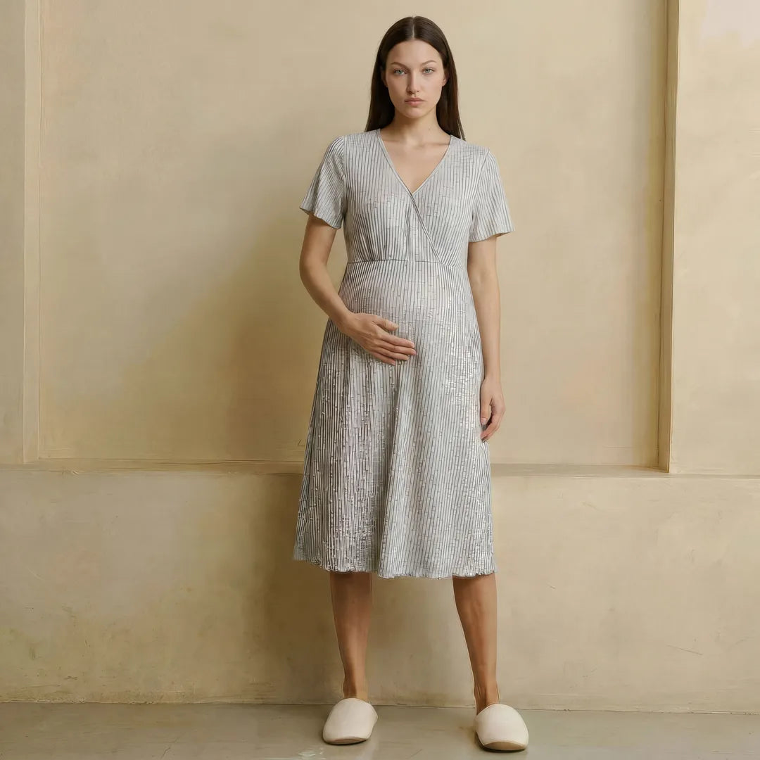 Blue postpartum night nursing dress wrap front flutter sleeves, lifestyle seated breastfeeding shot