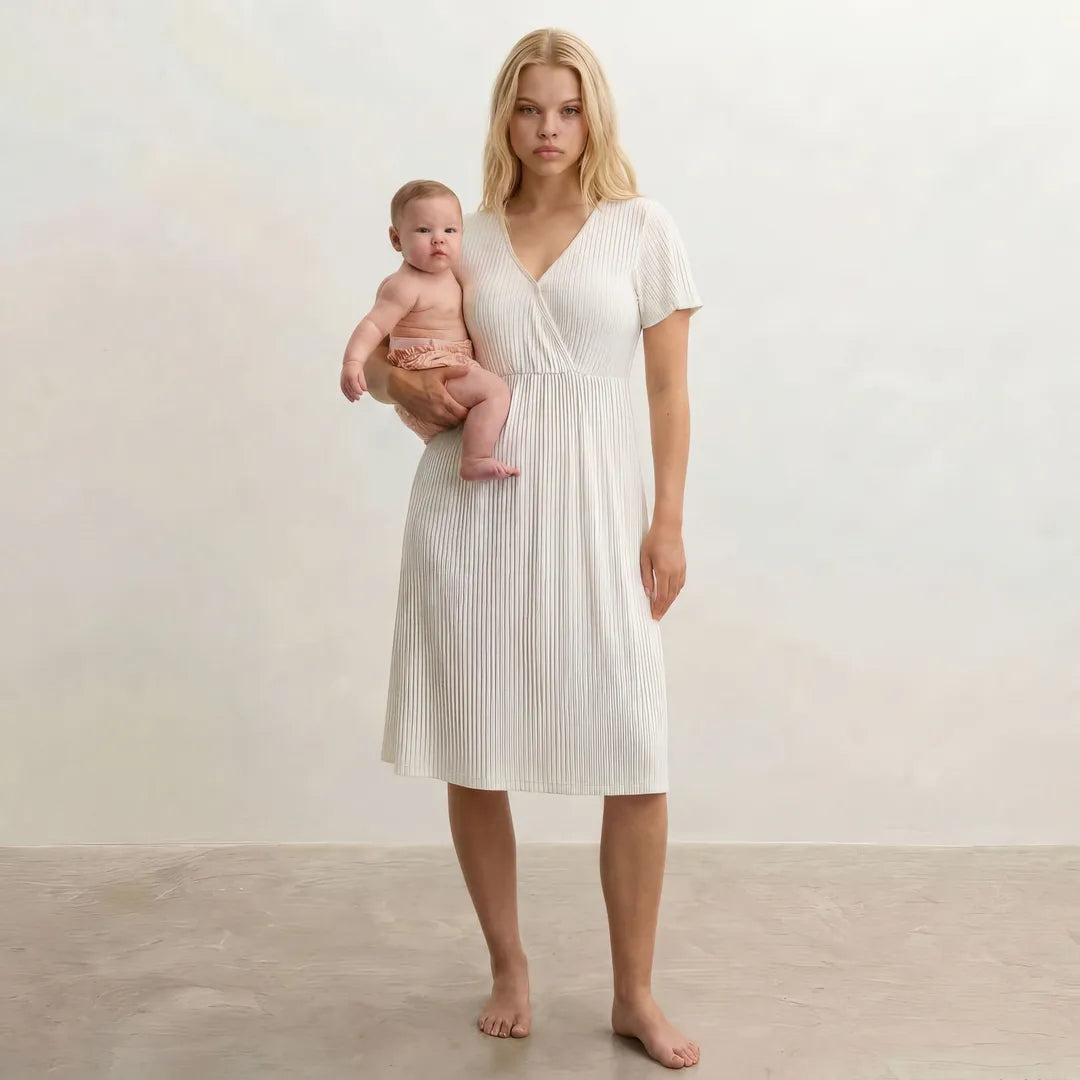 White postpartum night nursing dress ribbed wrap front flutter sleeves, full body lifestyle holding newborn shot