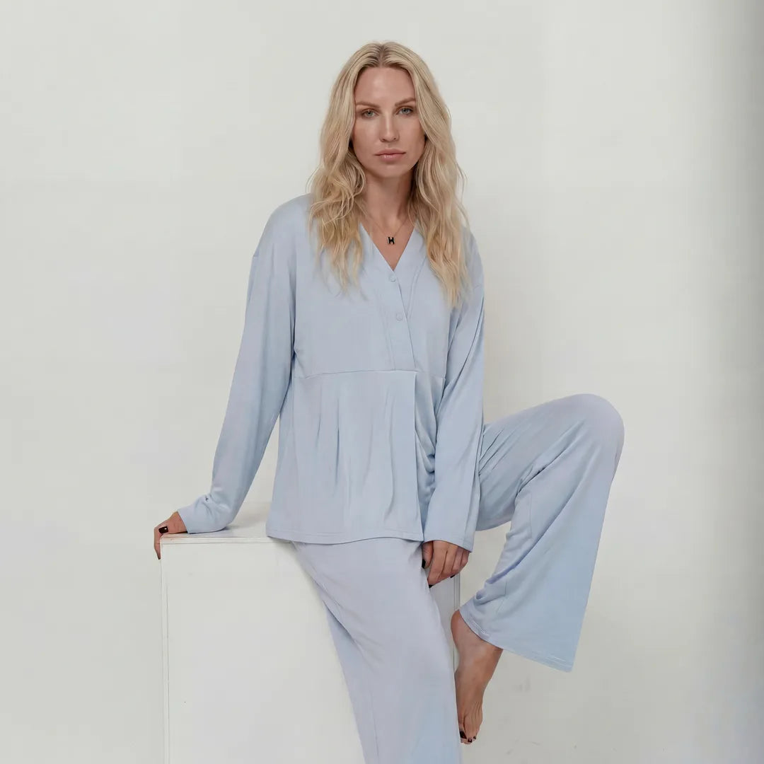 Blue maternity nursing pyjama set V-neck button top, leaning editorial studio shot