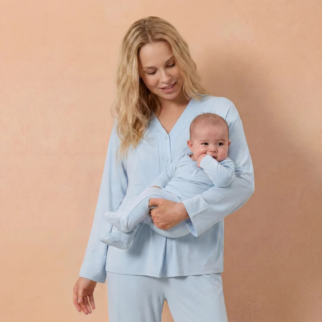 Blue maternity nursing pyjama set V-neck button nursing access, postpartum lifestyle shot with baby