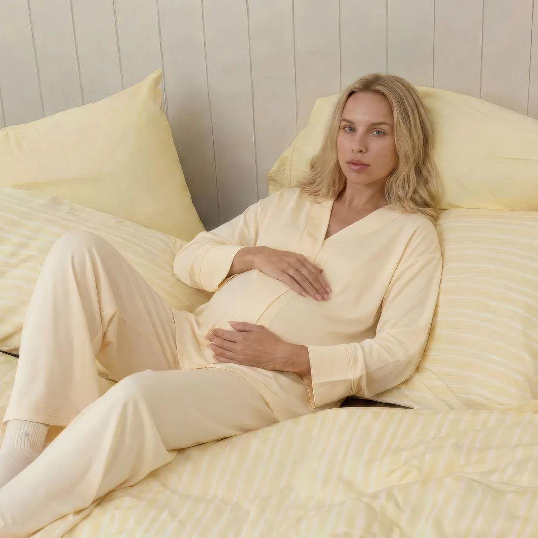 Yellow maternity nursing pyjama set long sleeve wide leg comfort, bed reclined lifestyle shot