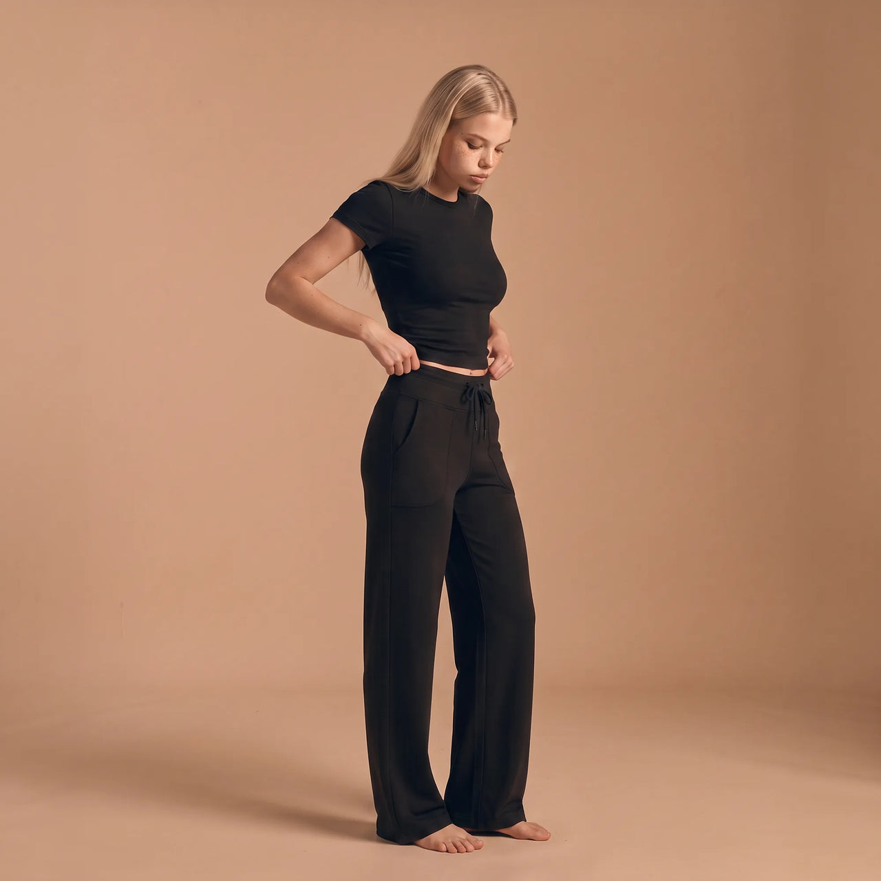 Black Pausa high-waisted drawstring wide-leg trousers, three-quarter view