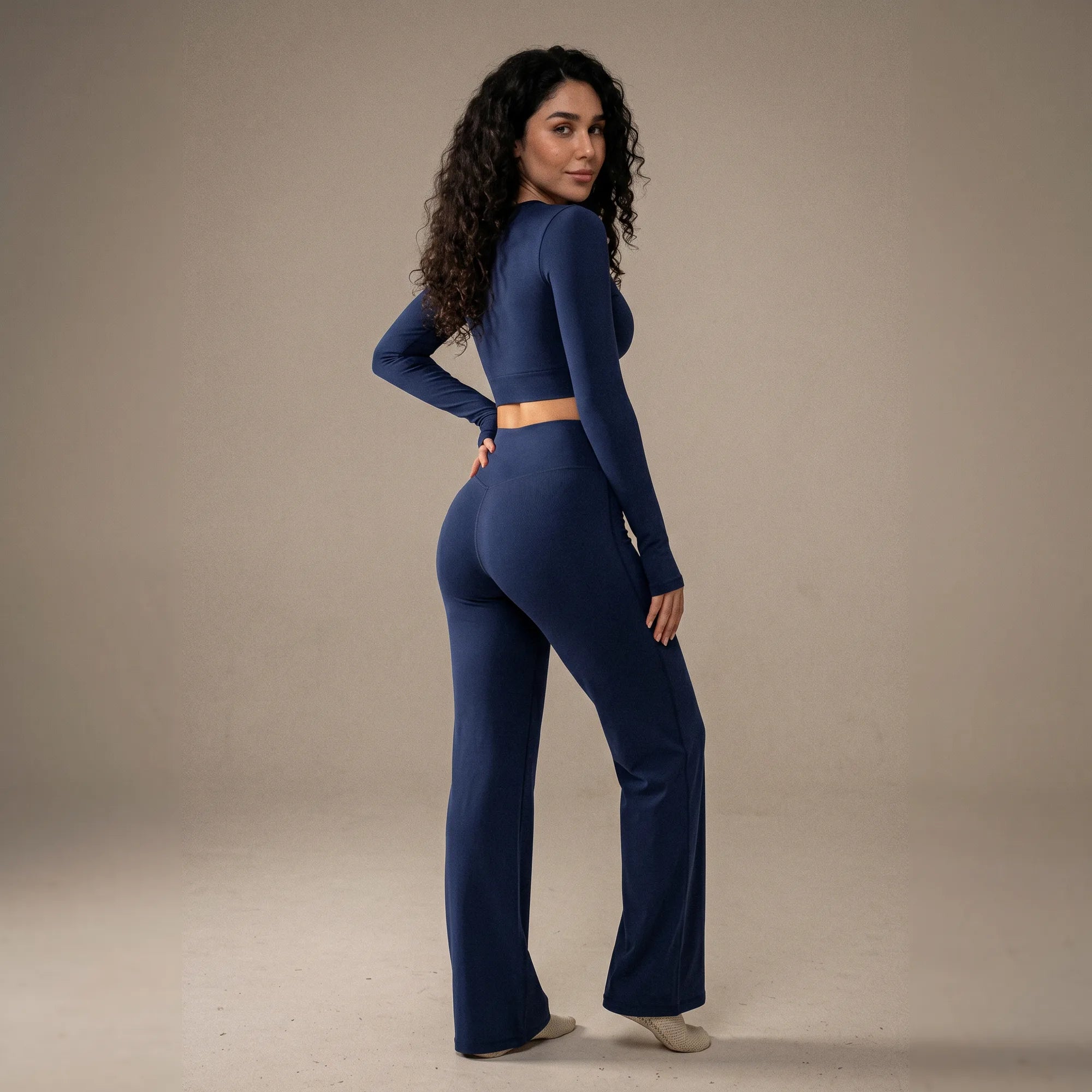  Woman wearing navy Pulso high-waisted wide-leg postpartum trouser, three-quarter back view