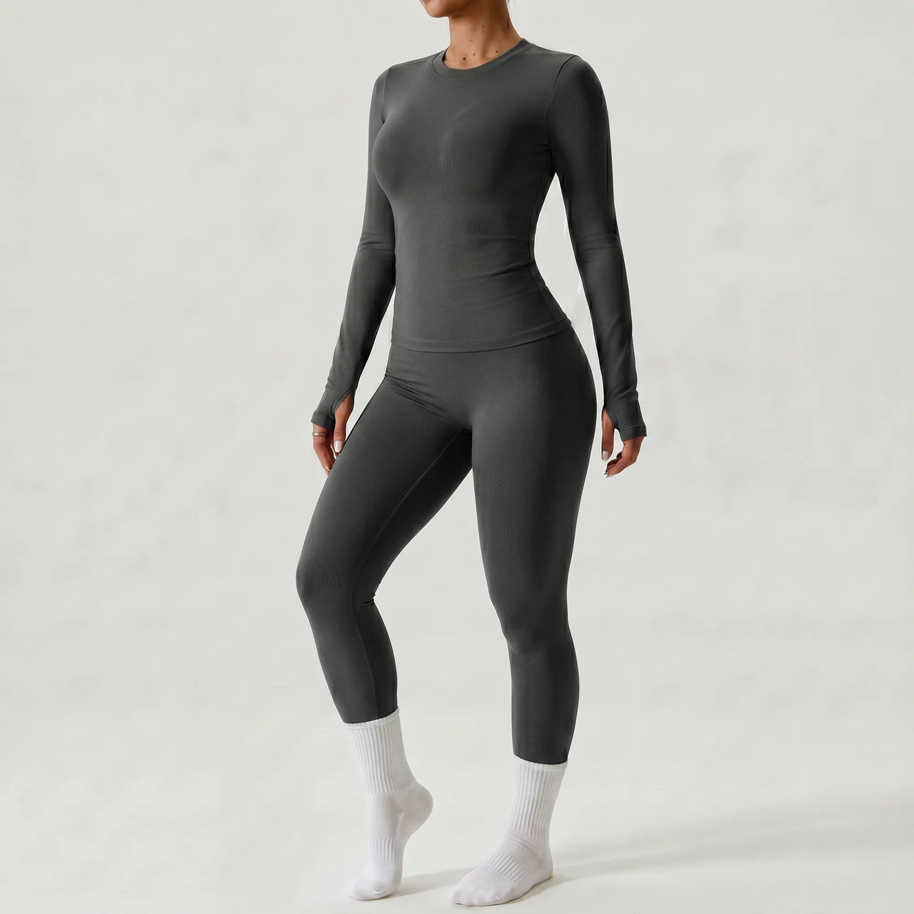 Woman wearing grey Retorno high-waisted postpartum legging, side view