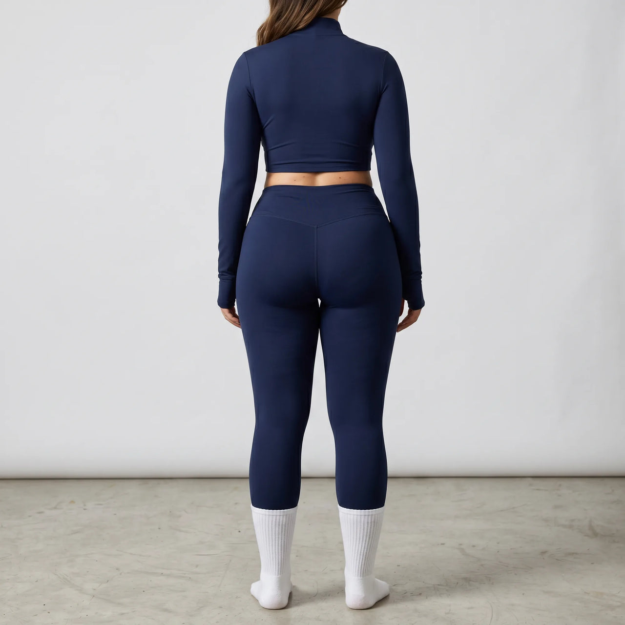 Woman wearing navy Retorno high-waisted postpartum legging, back view
