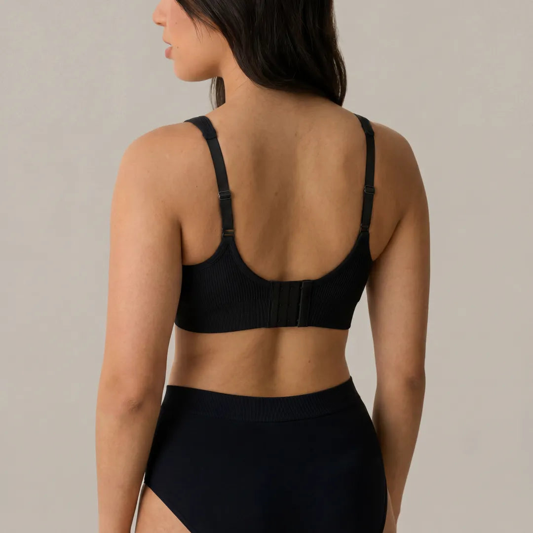 Black seamless nursing bra back hook-and-eye closure with adjustable straps, back view studio shot with matching underwear