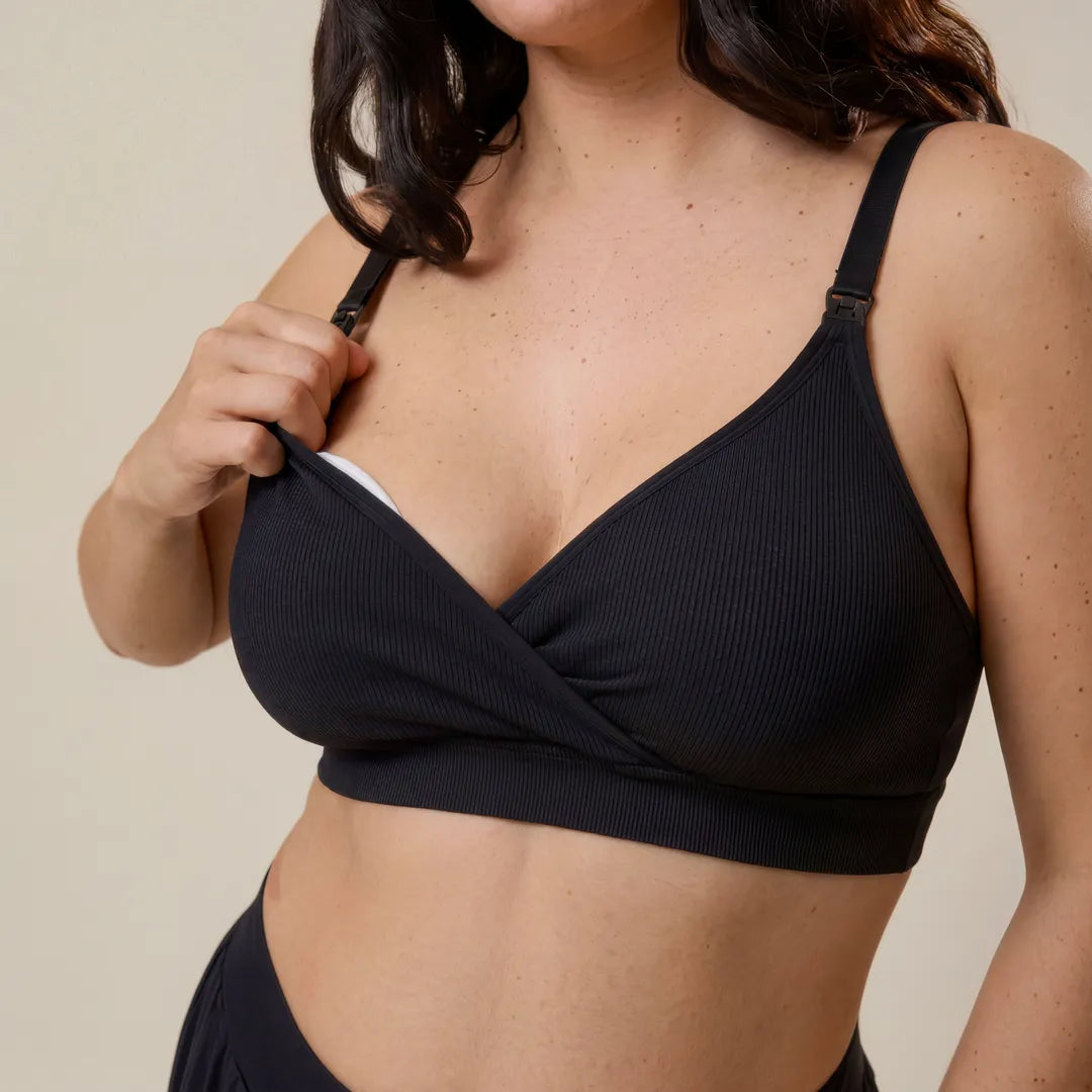 Black seamless nursing bra adjustable strap with drop-cup nursing clip, upper body clip access demonstration shot
