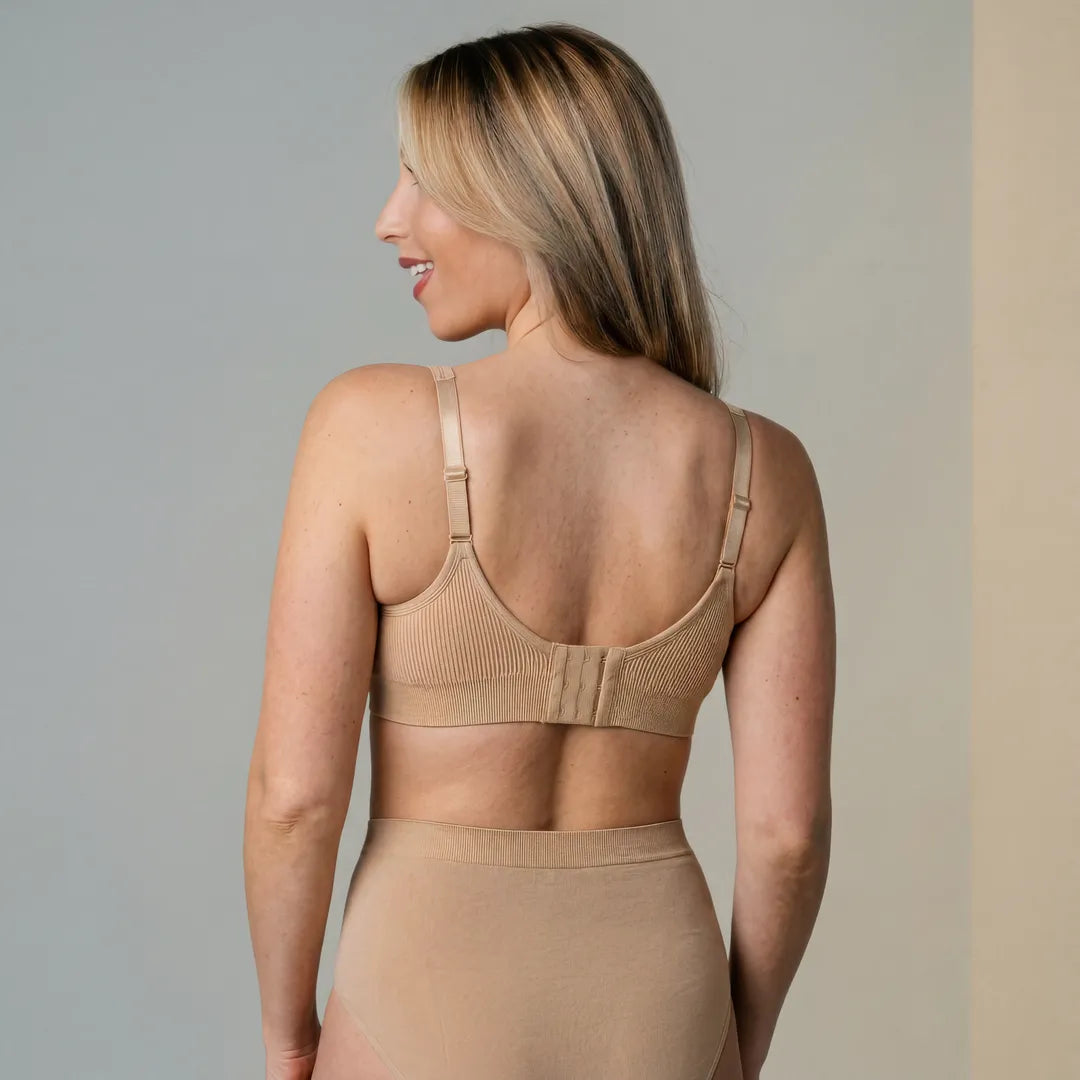 Nude seamless nursing bra back hook-and-eye closure multi-position straps, back view studio shot with matching underwear