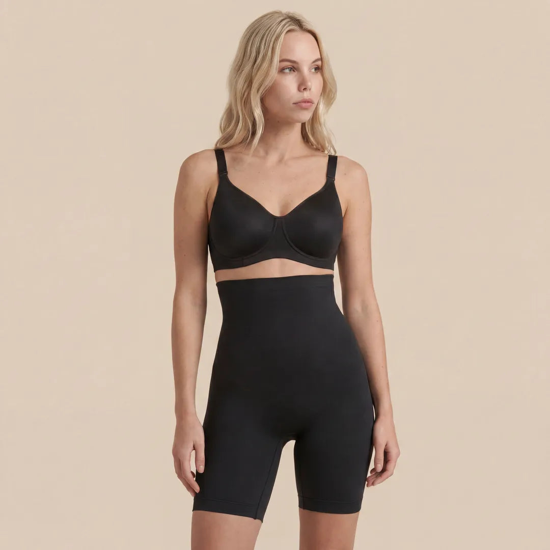 Woman wearing a black bra and high-waisted shorts on a beige background