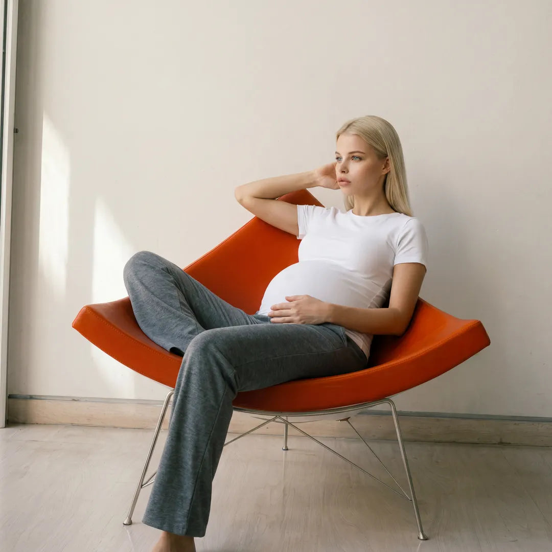 Charchoal wide maternity trousers lifestyle shot, model seated 