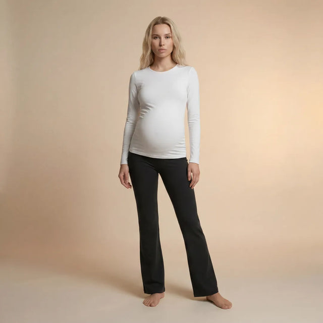 Black wide maternity trousers full length front view, beige studio