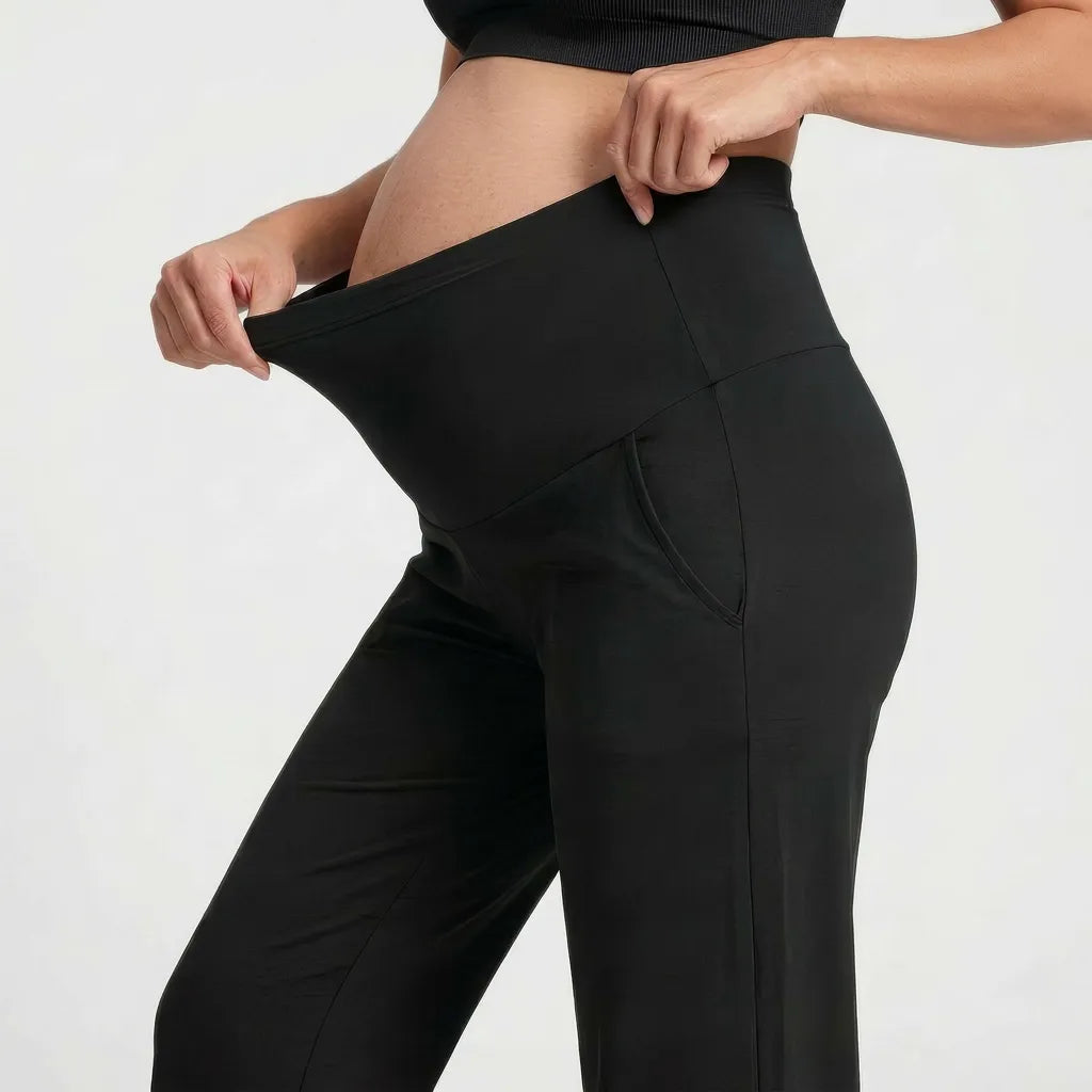 Black seamless yoga trousers over-bump waist panel, side close-up